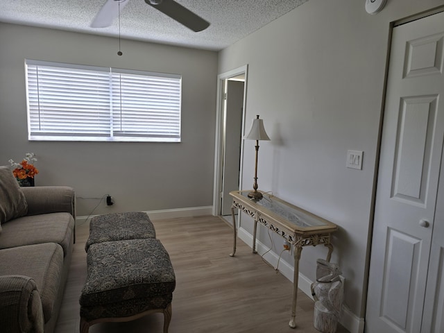 143 Lake Barbara Dr, West Palm Beach, FL 33411 - living area featuring a ceiling fan, light wood-style floors, a textured ceiling, and baseboards