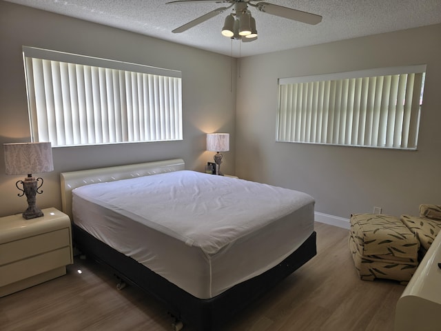 143 Lake Barbara Dr, West Palm Beach, FL 33411 - bedroom with wood finished floors, a textured ceiling, ceiling fan, and baseboards