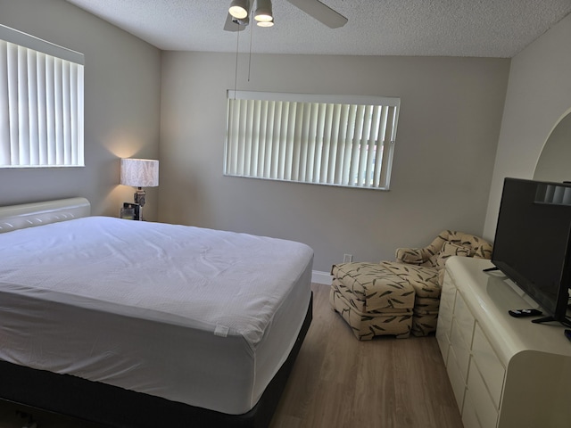 143 Lake Barbara Dr, West Palm Beach, FL 33411 - bedroom featuring wood finished floors, multiple windows, a textured ceiling, and ceiling fan