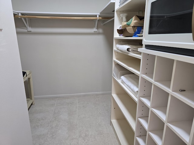 143 Lake Barbara Dr, West Palm Beach, FL 33411 - walk in closet with tile patterned flooring