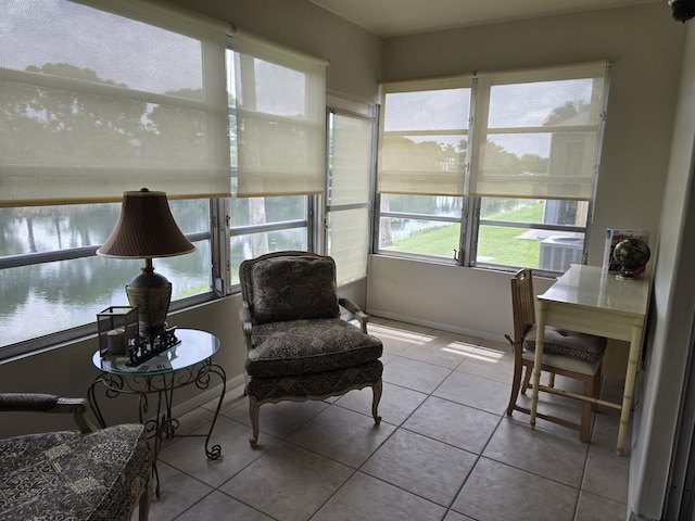 143 Lake Barbara Dr, West Palm Beach, FL 33411 - sunroom featuring tile patterned flooring, a water view, and baseboards