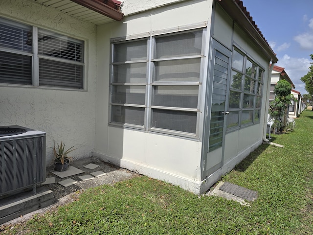 143 Lake Barbara Dr, West Palm Beach, FL 33411 - view of home's exterior featuring cooling unit, stucco siding, a yard, and a tiled roof