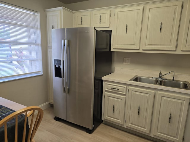 143 Lake Barbara Dr, West Palm Beach, FL 33411 - kitchen with stainless steel fridge with ice dispenser, a sink, light countertops, and light wood-style flooring