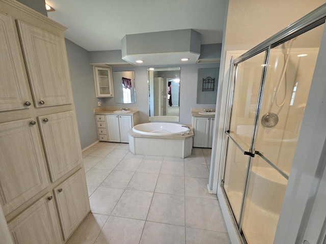 3817 SW Cheribon St, Port Saint Lucie, FL 34953 - bathroom featuring a shower stall, two vanities, a bath, and tile patterned flooring