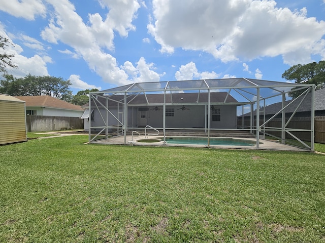 3817 SW Cheribon St, Port Saint Lucie, FL 34953 - back of property featuring a ceiling fan, a patio area, glass enclosure, and an outdoor pool
