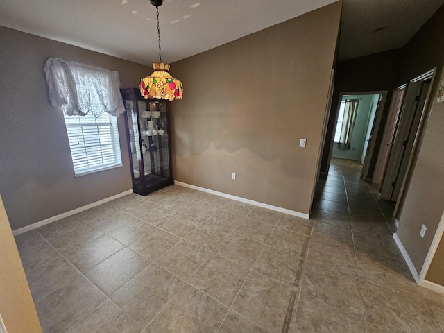 3817 SW Cheribon St, Port Saint Lucie, FL 34953 - unfurnished dining area with light tile patterned flooring and baseboards
