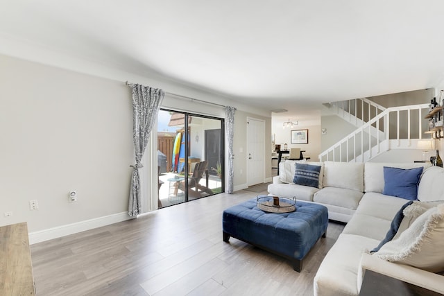 3900 County Line Rd Unit 4C, Tequesta, FL 33469 - living area with stairway, wood finished floors, and baseboards