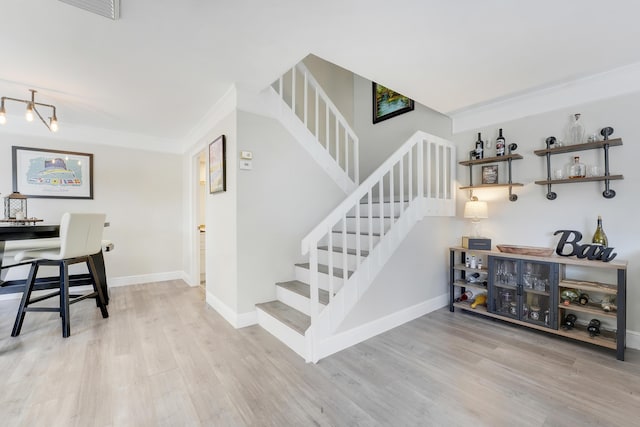 3900 County Line Rd Unit 4C, Tequesta, FL 33469 - stairs with wood finished floors, baseboards, and crown molding