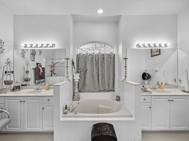 1081 SW Jacqueline Ave, Port Saint Lucie, FL 34953 - bathroom with a garden tub, two vanities, and a shower