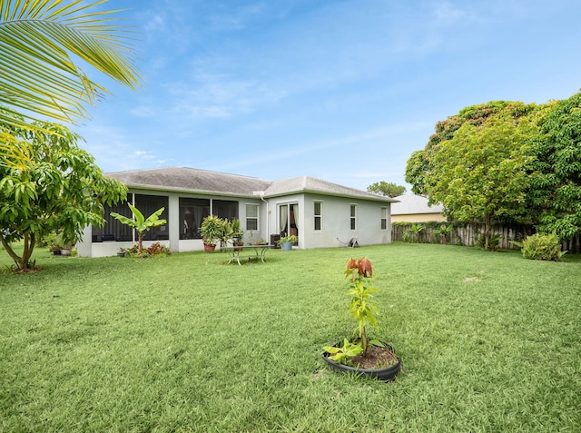 1081 SW Jacqueline Ave, Port Saint Lucie, FL 34953 - back of house featuring a sunroom, a shingled roof, and stucco siding