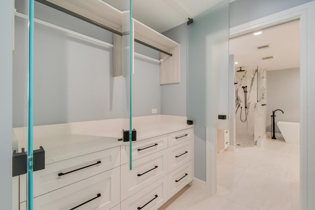 438 River Edge Rd, Jupiter, FL 33477 - walk in closet with light tile patterned flooring