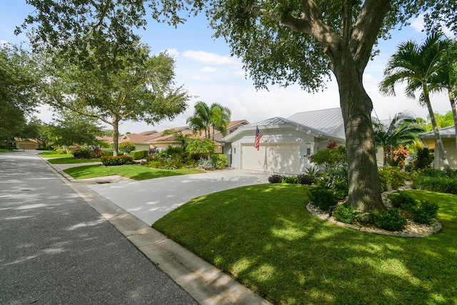 438 River Edge Rd, Jupiter, FL 33477 - view of front of house featuring a front lawn, an attached garage, and driveway