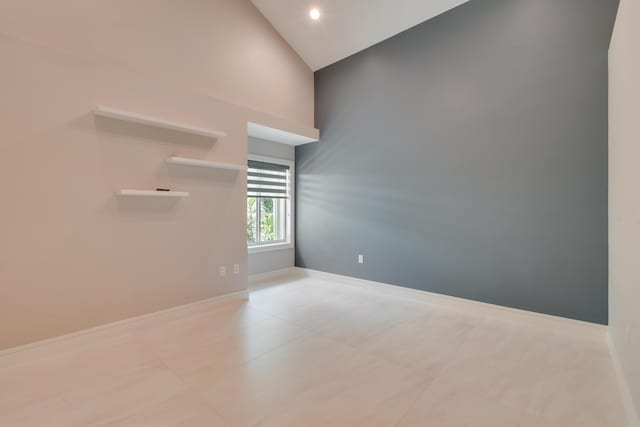 438 River Edge Rd, Jupiter, FL 33477 - tiled empty room with high vaulted ceiling and baseboards