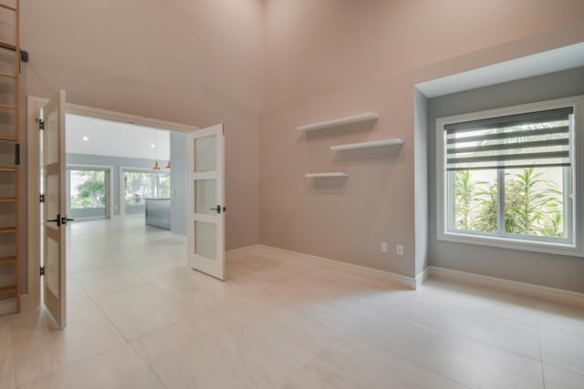 438 River Edge Rd, Jupiter, FL 33477 - empty room featuring light tile patterned floors and baseboards