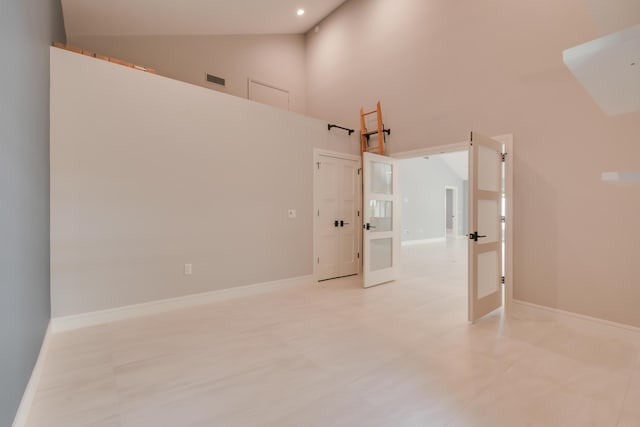438 River Edge Rd, Jupiter, FL 33477 - spare room with high vaulted ceiling and baseboards
