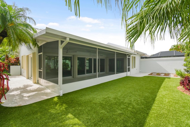 438 River Edge Rd, Jupiter, FL 33477 - rear view of house featuring a sunroom, a ceiling fan, a patio, and stucco siding