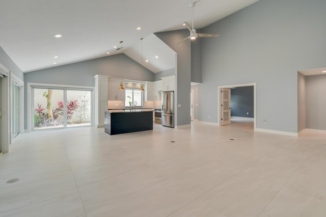 438 River Edge Rd, Jupiter, FL 33477 - unfurnished living room with high vaulted ceiling, a ceiling fan, healthy amount of natural light, recessed lighting, and a sink