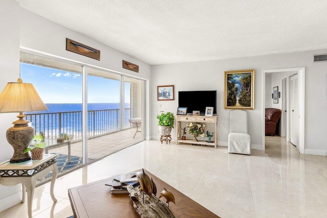 3101 S Ocean Blvd Unit 706, Highland Beach, FL 33487 - living room with a textured ceiling and baseboards