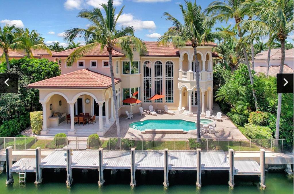 784 Harbour Isles Pl, North Palm Beach, FL 33410 - rear view of property featuring french doors, a patio area, stucco siding, a tiled roof, and a water view