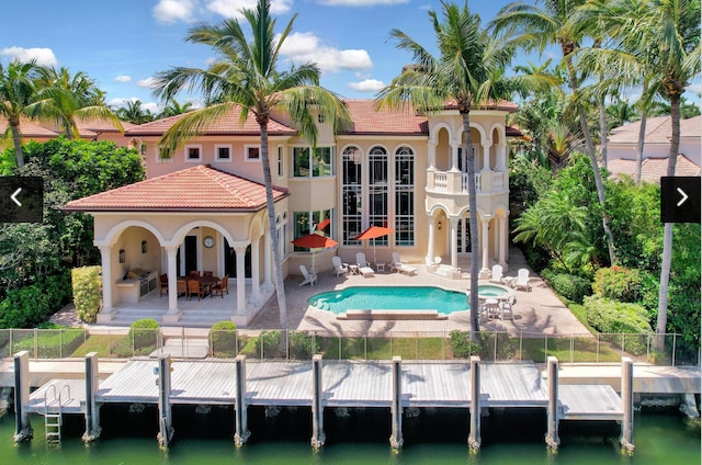 784 Harbour Isles Pl, North Palm Beach, FL 33410 - rear view of property featuring french doors, a patio area, stucco siding, a tiled roof, and a water view