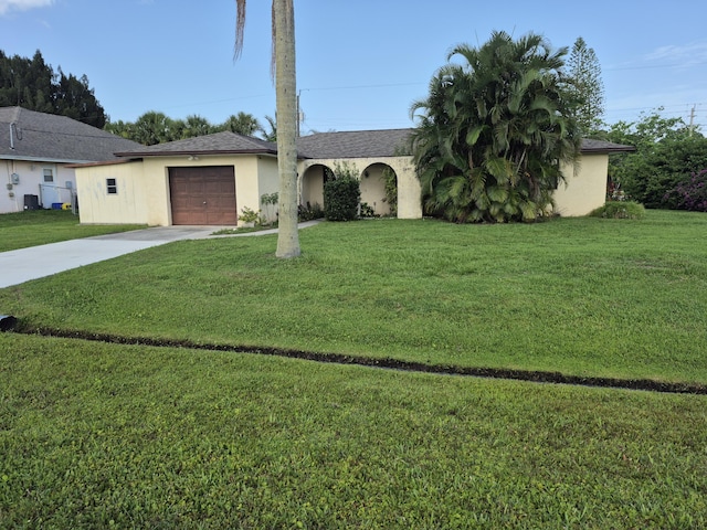 2897 SW Ortega St, Port Saint Lucie, FL 34953 - ranch-style house featuring concrete driveway, an attached garage, stucco siding, and a front lawn