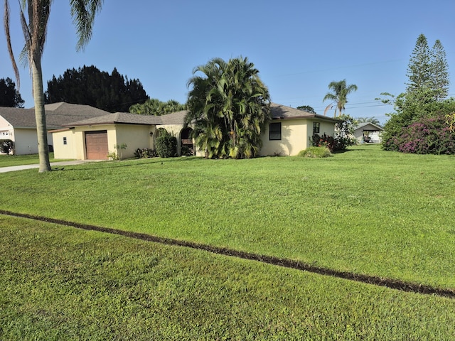 2897 SW Ortega St, Port Saint Lucie, FL 34953 - ranch-style house featuring an attached garage, stucco siding, and a front yard