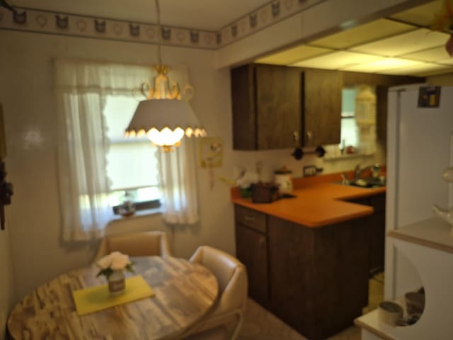 2897 SW Ortega St, Port Saint Lucie, FL 34953 - kitchen with light countertops and a peninsula