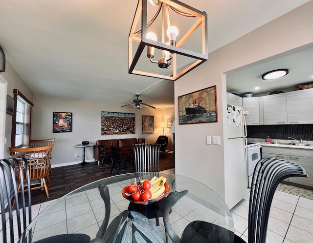 104 Cambridge E, West Palm Beach, FL 33417 - dining space with ceiling fan, a chandelier, baseboards, and light tile patterned flooring