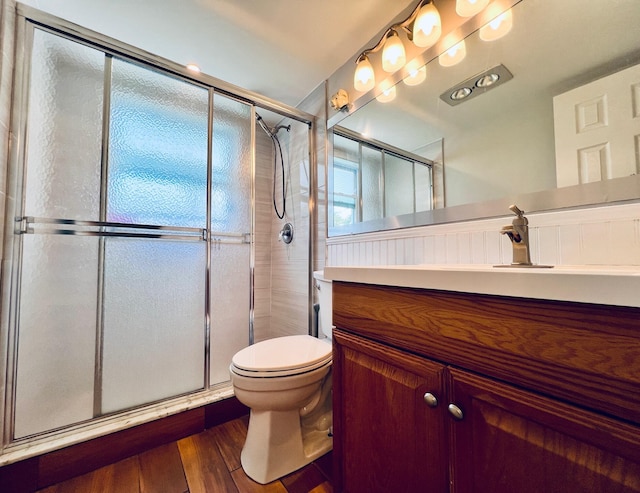 104 Cambridge E, West Palm Beach, FL 33417 - bathroom with toilet, vanity, a stall shower, and wood finished floors