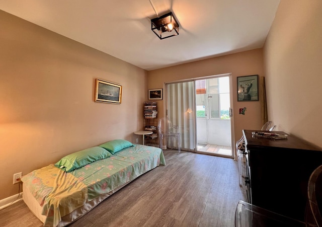 104 Cambridge E, West Palm Beach, FL 33417 - bedroom with access to exterior and wood finished floors