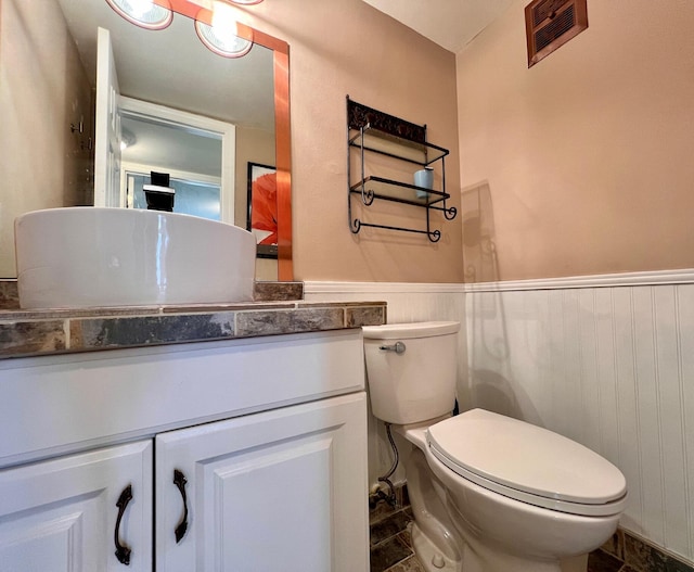 104 Cambridge E, West Palm Beach, FL 33417 - bathroom featuring toilet, wainscoting, and vanity