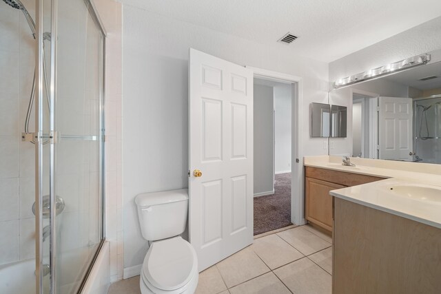 5554 Boynton Gardens Dr, Boynton Beach, FL 33437 - full bathroom featuring vanity, toilet, shower / bath combination with glass door, tile patterned floors, and baseboards
