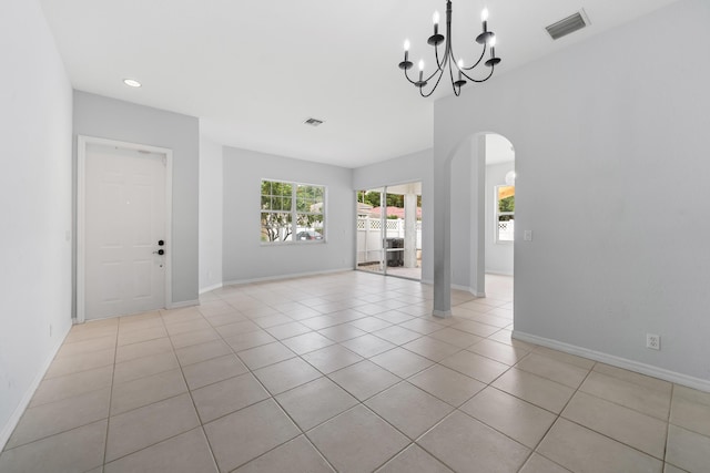 5554 Boynton Gardens Dr, Boynton Beach, FL 33437 - empty room with arched walkways, a chandelier, light tile patterned flooring, recessed lighting, and baseboards
