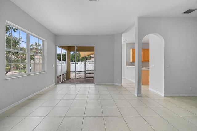 5554 Boynton Gardens Dr, Boynton Beach, FL 33437 - unfurnished room featuring arched walkways, baseboards, and light tile patterned floors