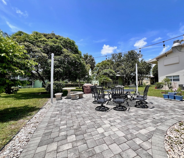 80 Norwich D, West Palm Beach, FL 33417 - view of patio / terrace featuring outdoor dining area and an outdoor fire pit