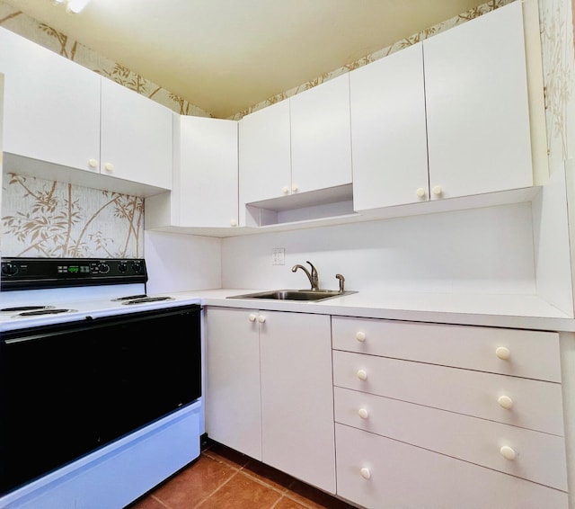 80 Norwich D, West Palm Beach, FL 33417 - kitchen with range with electric cooktop, light countertops, white cabinets, and tile patterned flooring
