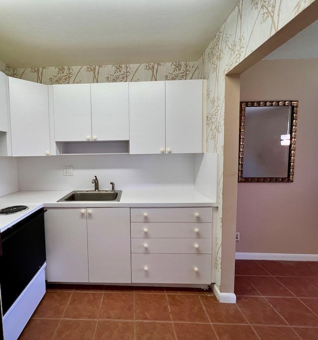 80 Norwich D, West Palm Beach, FL 33417 - kitchen featuring range with electric stovetop, light countertops, white cabinets, and tile patterned floors