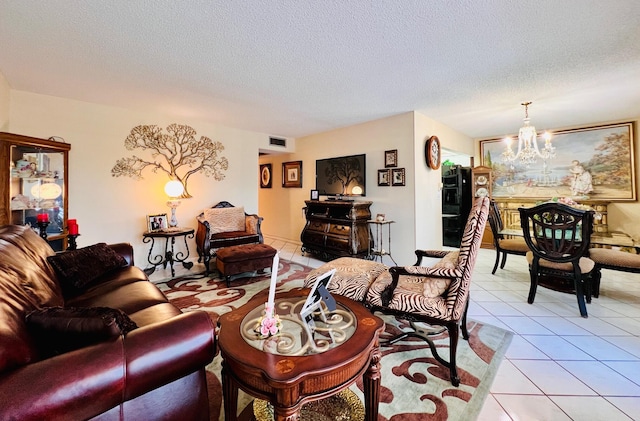 226 Wellington Unit G, West Palm Beach, FL 33417 - living room featuring a chandelier, light tile patterned flooring, and a textured ceiling