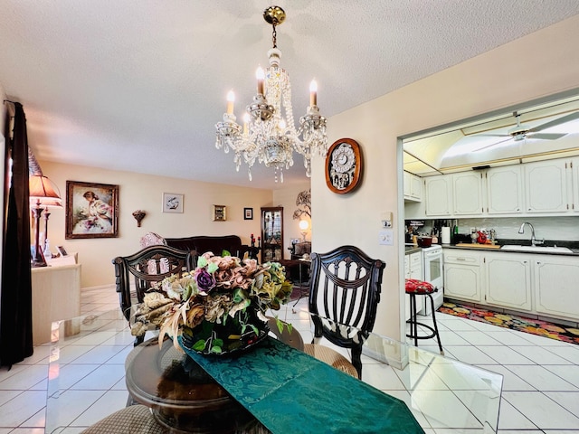 226 Wellington Unit G, West Palm Beach, FL 33417 - dining space with a chandelier, light tile patterned floors, and a textured ceiling