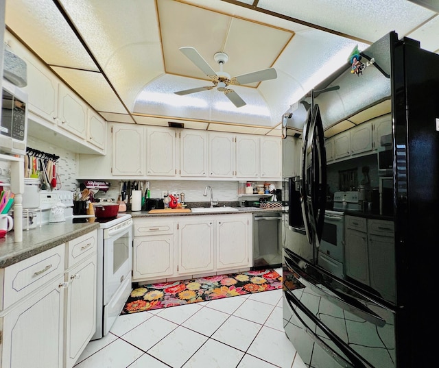 226 Wellington Unit G, West Palm Beach, FL 33417 - kitchen featuring stainless steel dishwasher, a sink, freestanding refrigerator, ceiling fan, and white electric range oven