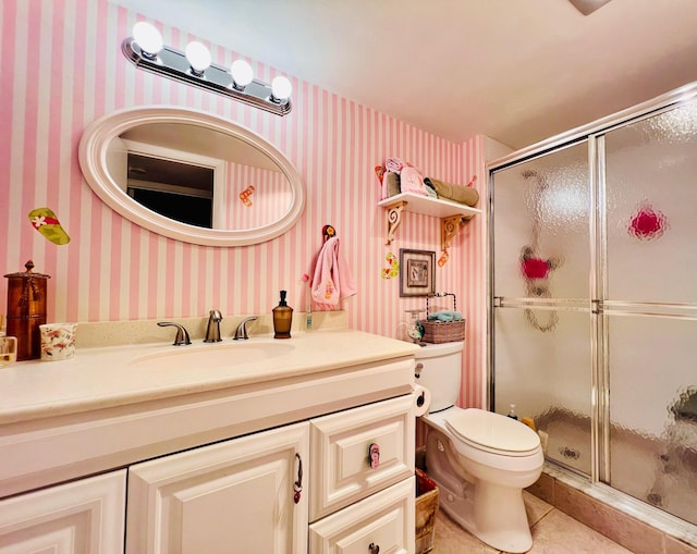 226 Wellington Unit G, West Palm Beach, FL 33417 - full bathroom with wallpapered walls, a shower stall, vanity, toilet, and tile patterned floors