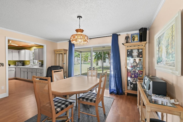 6506 Kings Hwy, Fort Pierce, FL 34951 - dining area with light wood finished floors, ornamental molding, a textured ceiling, and a chandelier