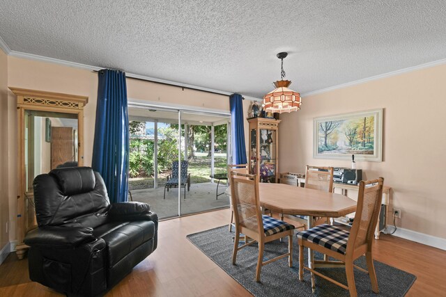 6506 Kings Hwy, Fort Pierce, FL 34951 - dining area featuring wood finished floors, ornamental molding, a textured ceiling, and baseboards