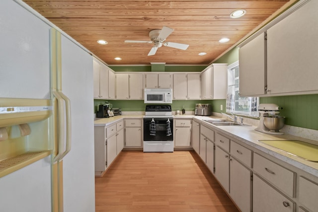 6506 Kings Hwy, Fort Pierce, FL 34951 - kitchen featuring white appliances, a sink, wood ceiling, light wood-style flooring, and light countertops
