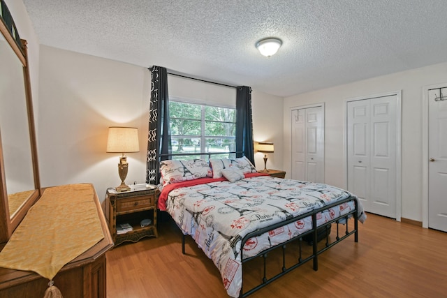 6506 Kings Hwy, Fort Pierce, FL 34951 - bedroom featuring a textured ceiling, wood finished floors, and multiple closets