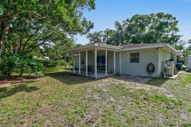 6506 Kings Hwy, Fort Pierce, FL 34951 - back of property featuring a patio area, stucco siding, and a yard