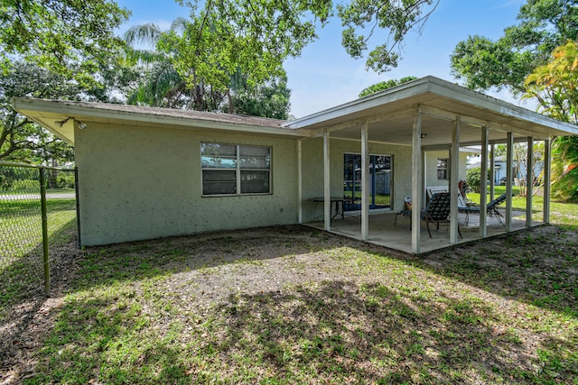 6506 Kings Hwy, Fort Pierce, FL 34951 - back of house featuring stucco siding and a patio