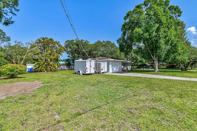 6506 Kings Hwy, Fort Pierce, FL 34951 - view of grassy yard featuring driveway and a garage