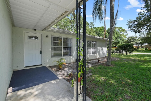 6506 Kings Hwy, Fort Pierce, FL 34951 - property entrance with a yard and stucco siding