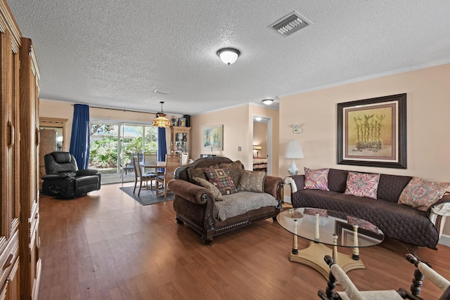 6506 Kings Hwy, Fort Pierce, FL 34951 - living room featuring wood finished floors, a textured ceiling, and ornamental molding